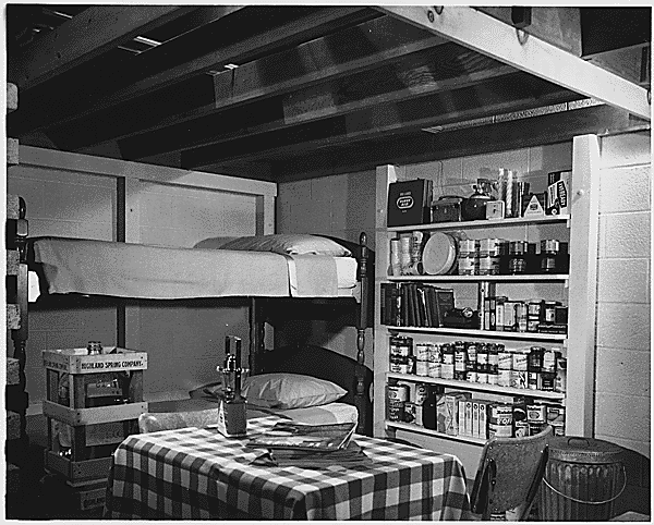  Photograph of a basement family fallout shelter that includes a 14-day food supply that could be stored indefinitely, a battery-operated radio, auxiliary light sources, a two-week supply of water, and first aid, sanitary, and other miscellaneous supplies and equipment, ca.1957.