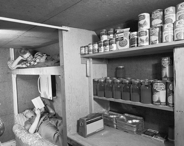 c. 1960. Fallout shelter built by Louis Severance adjacent to his home near Akron, Mich., includes a special ventilation and escape hatch, an entrance to his basement, tiny kitchen, running water, sanitary facilities, and a sleeping and living area for the family of four. The shelter cost about $1,000. It has a 10-inch reinforced concrete ceiling with thick earth cover and concrete walls. Severance says, 'Ever since I was convinced what damage H-Bombs can do, I've wanted to build the shelter. Just as with my chicken farm, when there's a need I build it." 