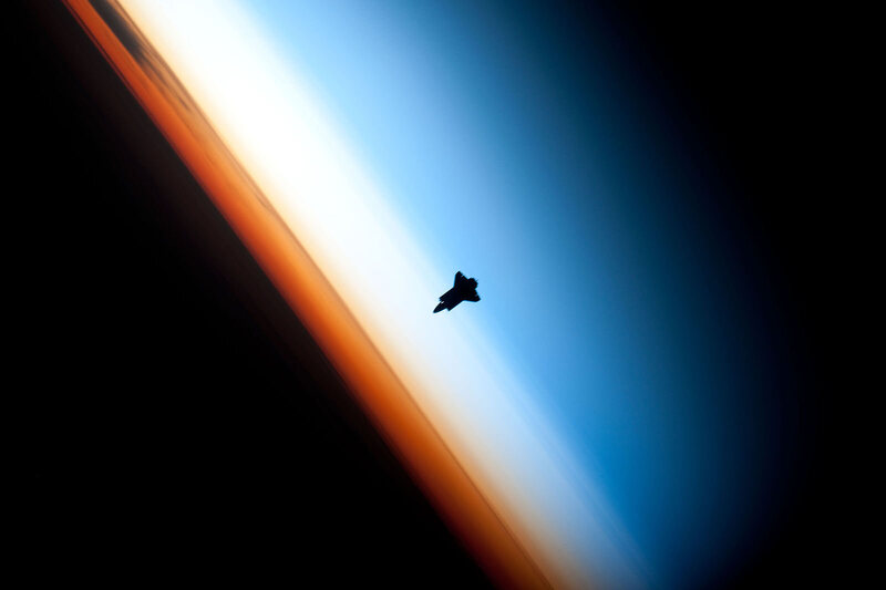The Space Shuttle Endeavor, silhouetted on the mesosphere.