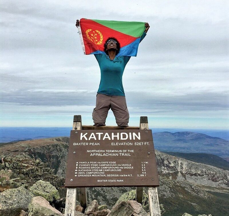 Haile at the top of Katahdin holding an Eritrean flag.
