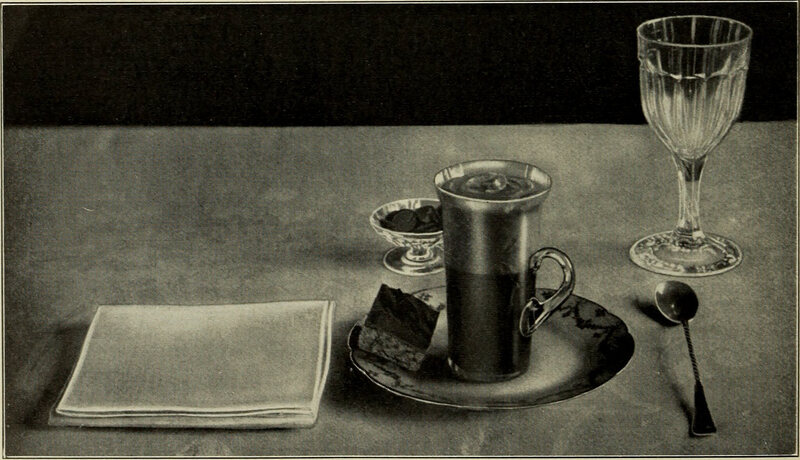 A place setting with a napkin from <em>American Cookery</em>, 1914. 