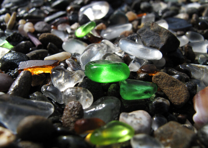 A close-up of glass pebbles worn down by ocean waves, originally pieces of bottles and dishes, on Glass Beach in Fort Bragg, California. 