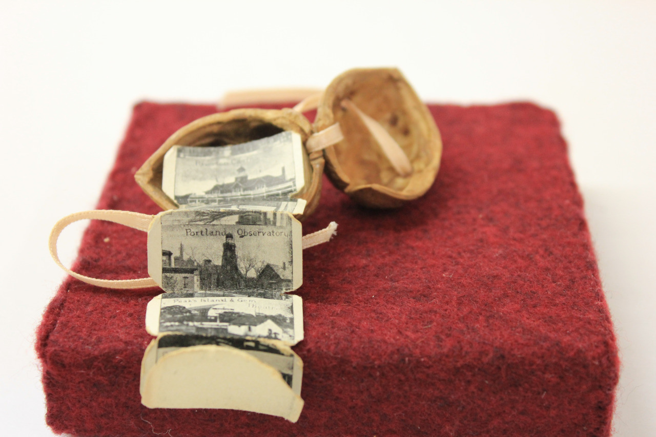 Popular in the early 20th century as souvenir books, these tiny books of travel photos (Maine, in this case) had tags attached so they could be dropped in the mail. 