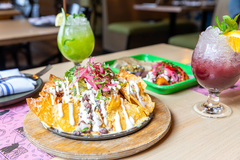 At Mister Oso, generous portions, fruity cocktails, and loaded nachos make every meal a party. 