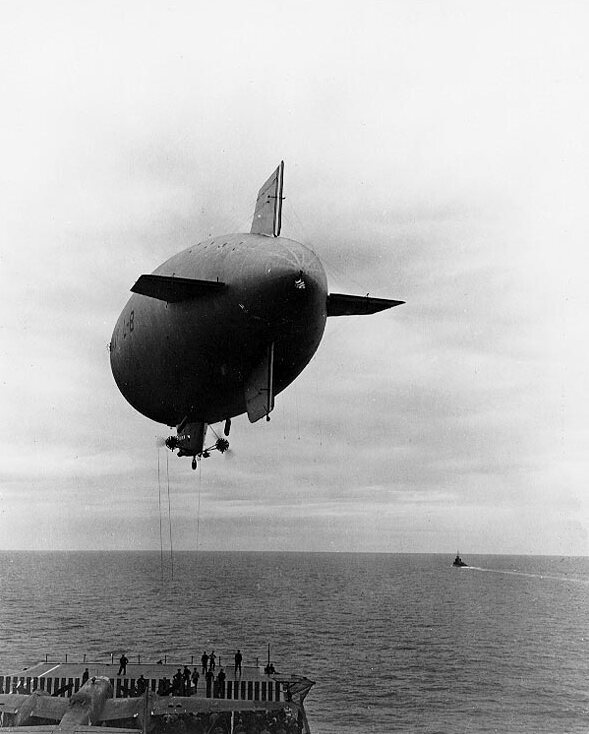 A US Navy L-8 blimp in action over the aircraft carrier USS Hornet.