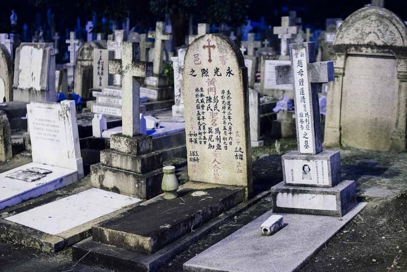  Graves of Chinese Catholics at St. Michael's Cemetery. The monuments on the right blend western-style tombstones with Chinese funerary elements -- one has an incense bowl, while the other incorporates a name tablet into the cross.