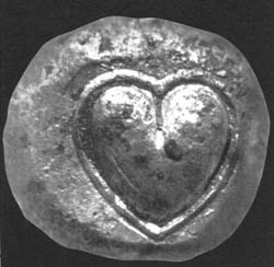 A Cyrenian coin from the 6th century B.C., with a silphium seed imprinted in it.