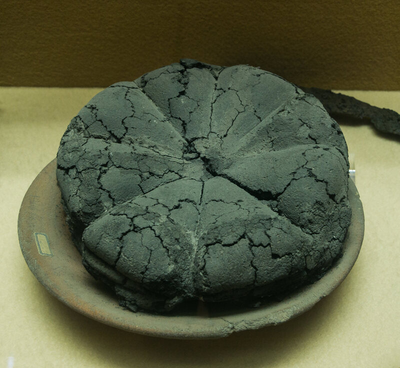This carbonized <em>panis quadratus</em> was preserved by the eruption of Mount Vesuvius. 