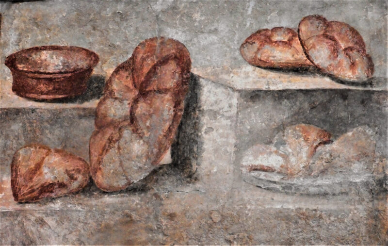 Some frescoes from Pompeii feature the <em>panis quadratus</em>. This one is now at the National Archaeological Museum of Naples.  