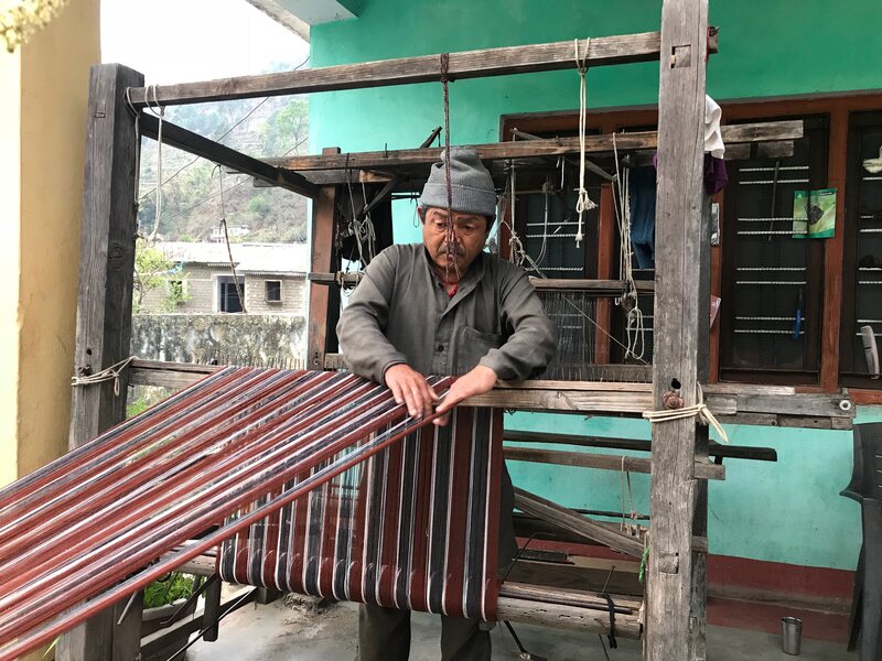 Shyam Singh Rana spinning wool on a loom in Dunda village, Uttarakhand