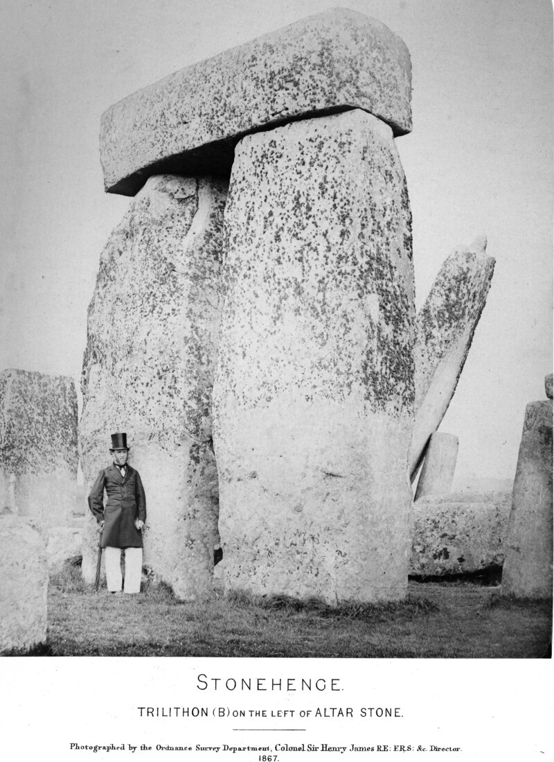 A man—possibly James—poses beneath a large piece of Stonehenge.