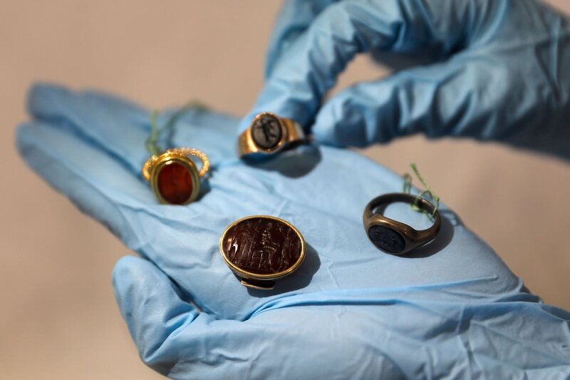 The curator Morag Wilhelm holds some of the signet rings Freud gave to his students.
