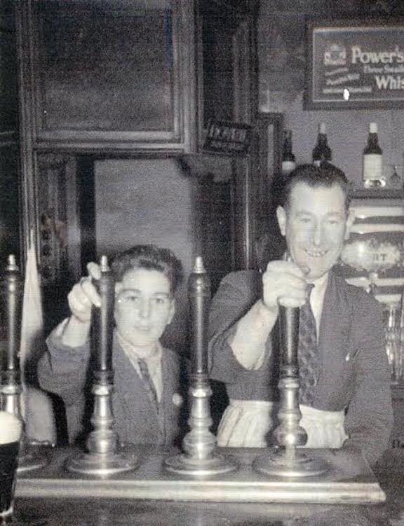 Eugene, aged 8, pulling a pint with his uncle Fintan at the pub.