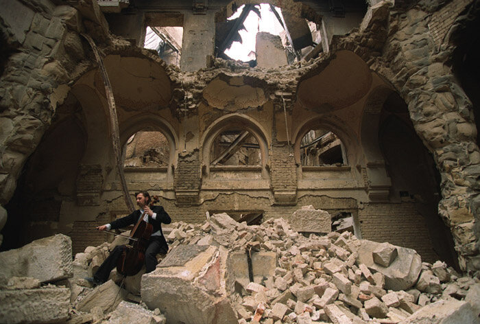 Cellist Vedran Smailović plays in the ruins of the National Library in Sarajevo in 1992. 