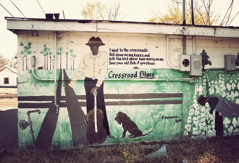 A mural of Johnson, with lyrics from "Cross Road Blues" in Baptist Town, Mississippi. 