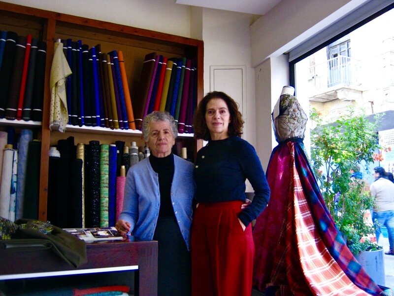 Eleni Michaelides and her mother stand together in their fabric store.
