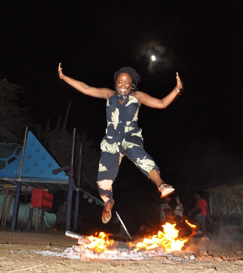 A woman jumps over a bonfire during a Bonairian festival. On the festival of San Juan, the tradition is said to be a plea for rain during the next sorghum growing season. On the festival of San Pedro, it is a prayer for calm winds for fishing. 