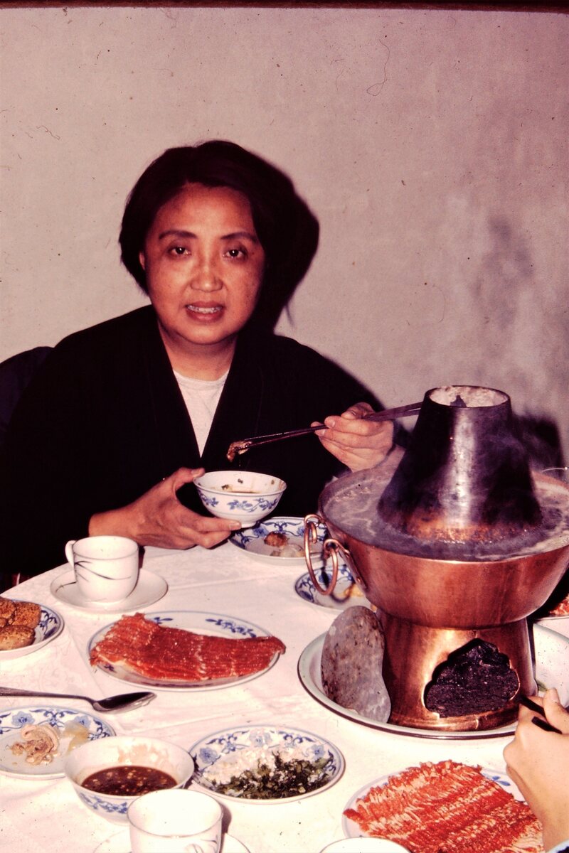Chen sitting down to hot pot in 1972.