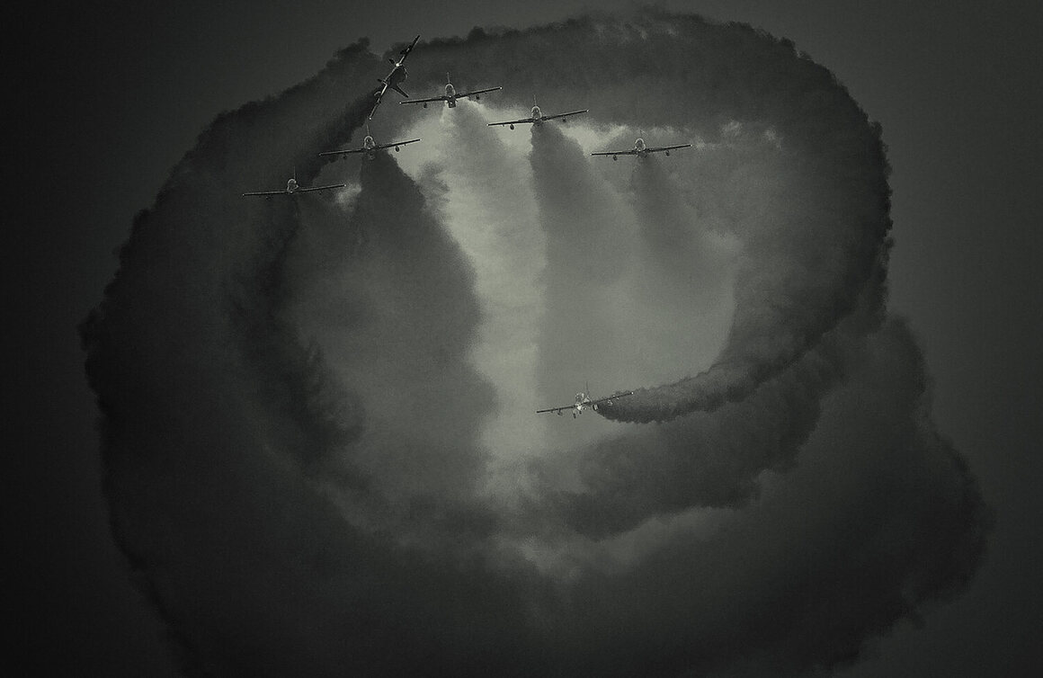 <em>SPIRAL</em>, showing the AL Fursan Aerobatic team of UAE performing an airshow. 