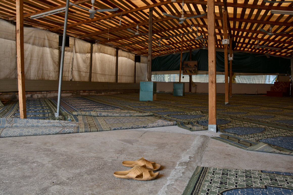 A Bangladeshi mosque in a three-story building's terrace. The terrace is usually closed and they only open it during big celebration days when many people are attending.