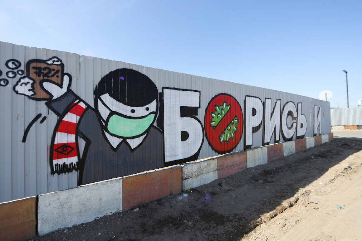 A mural reads "Fight!" near the construction site of a medical center's new building in Moscow, Russia, March 26, 2020.