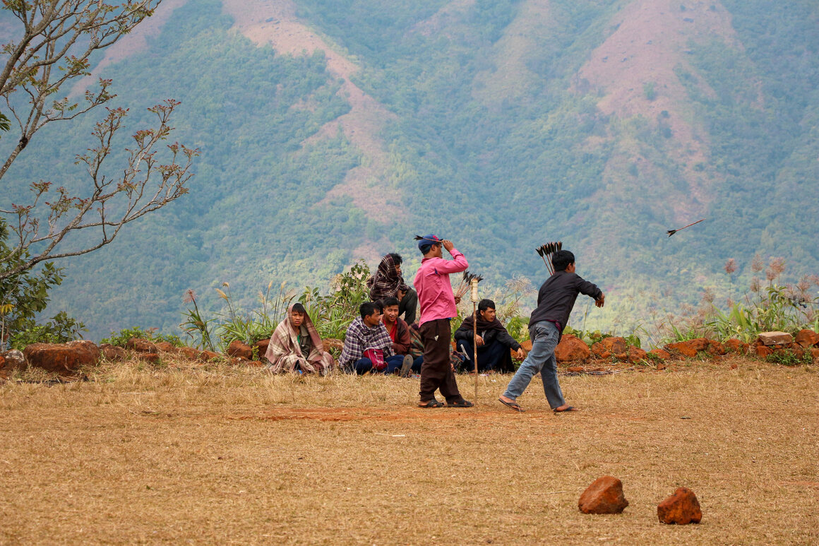 Locals play darts on the Kongthong football field in early 2020.