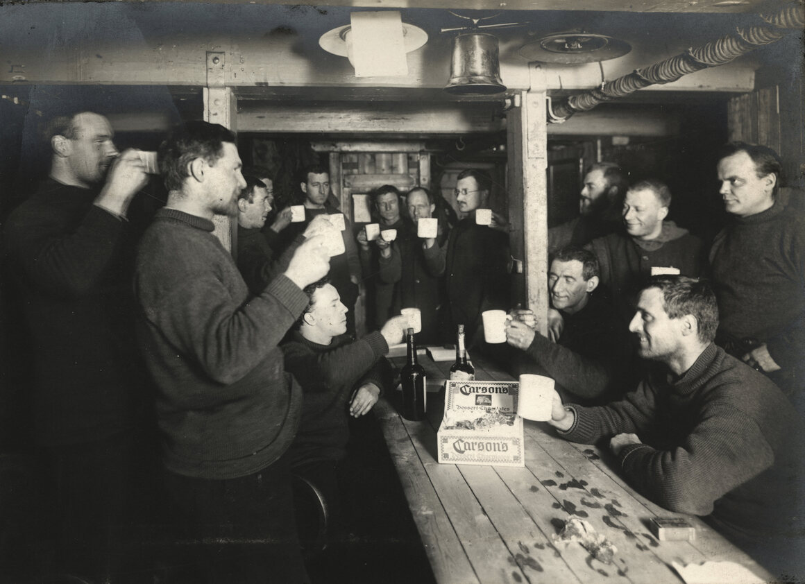 Crew members, pictured here aboard <em>Endurance</em> often raised toasts. 