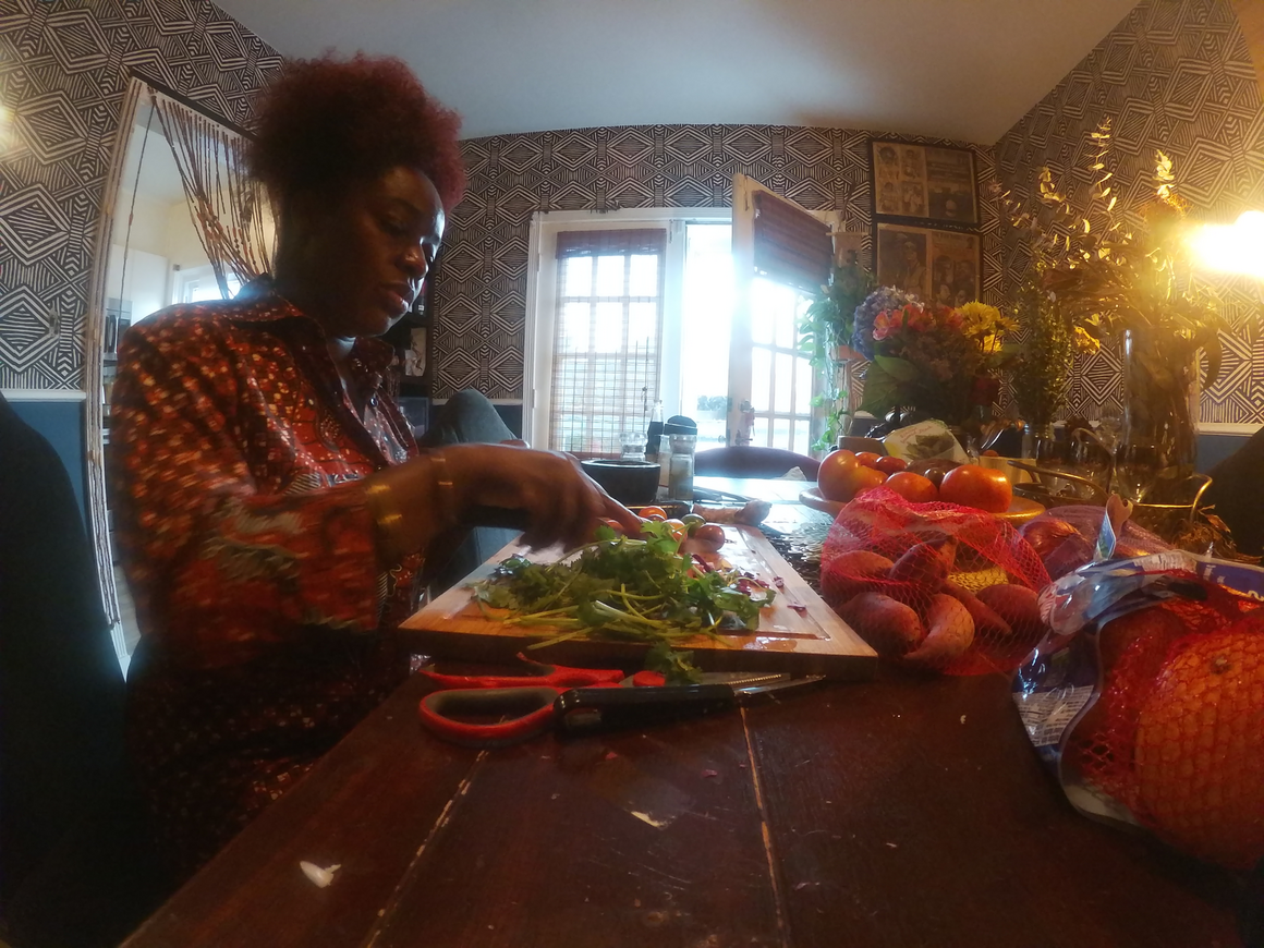 Sharayna Ashanti Christmas chops vegetables for a dinner party.
