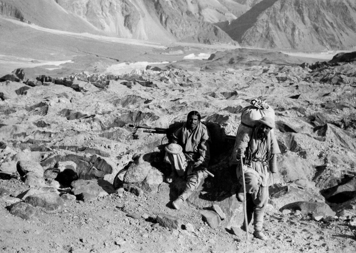 Porters pause on a trail in the Hunza Valley. The men were part of the Roosevelt brothers' hunting expedition through Central Asia in the 1920s.