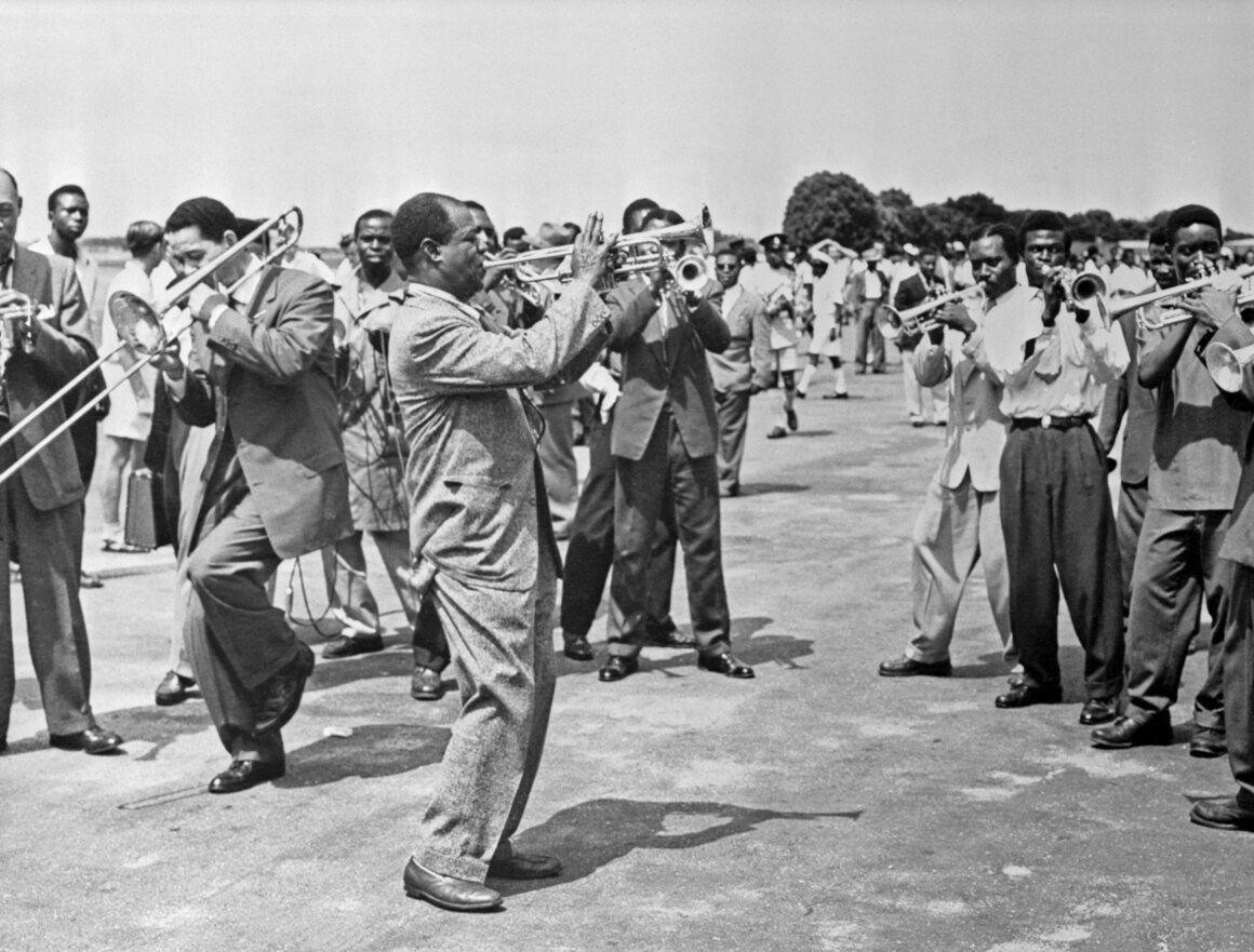 Louis Armstrong and his band perform for a crowd of some 40,000 gathered to greet him at the airport in Accra, Ghana, in the spring of 1956.