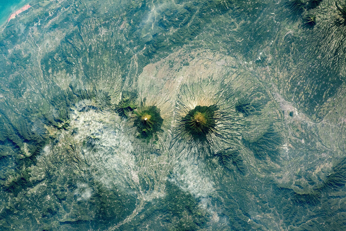 Seen from the International Space Station, twin volcanoes Sundoro and Sumbing (left to right) on the Indonesian island of Java. 