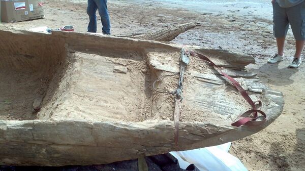 boaters discover a very old dugout canoe near a river in